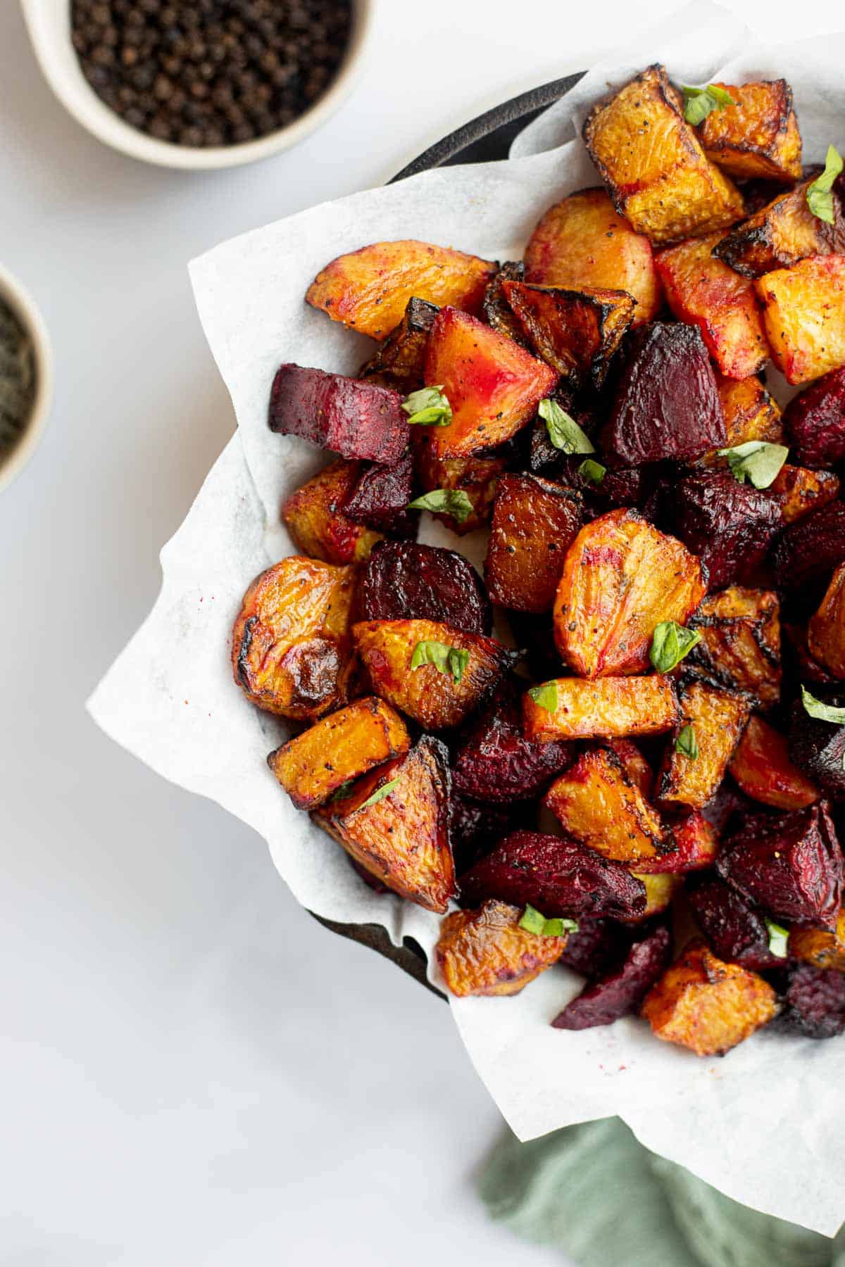 air fryer beets on parchment paper in iron pan.