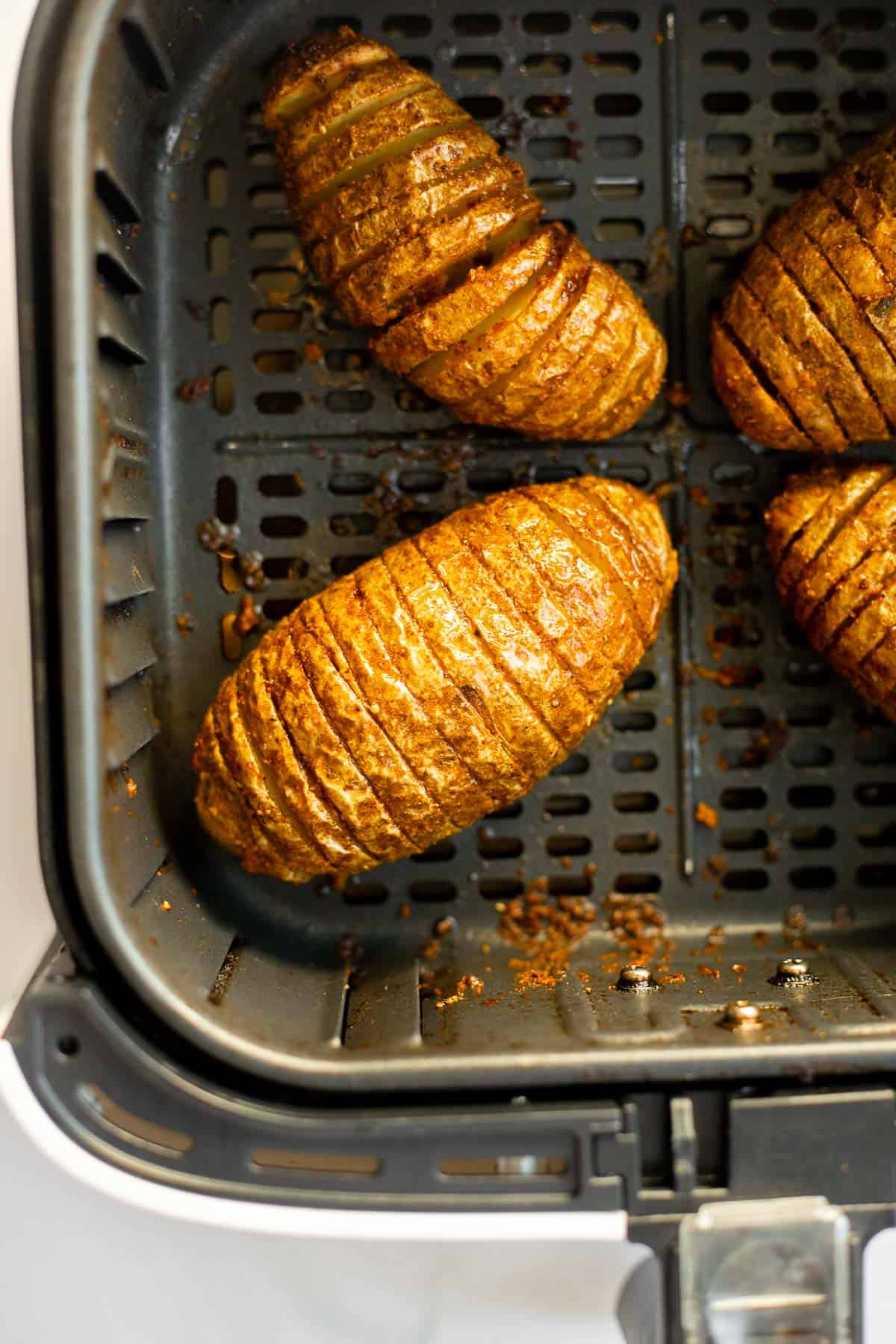 hasselback potatoes cooked in air fryer basket.