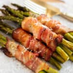 air fryer bacon wrapped asparagus on parchment paper.