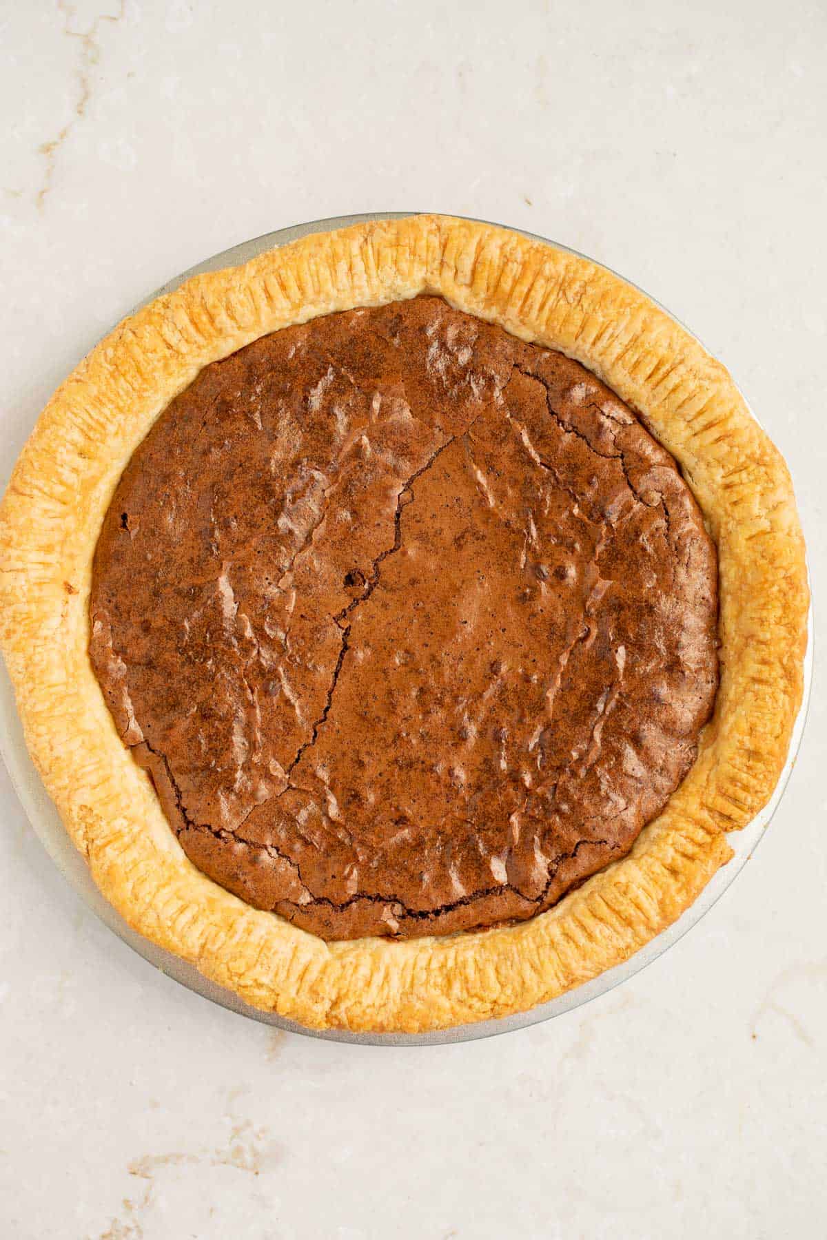 brownies baked into pie crust on a white background.