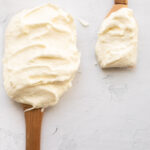 cream cheese frosting without butter on 2 spatulas.