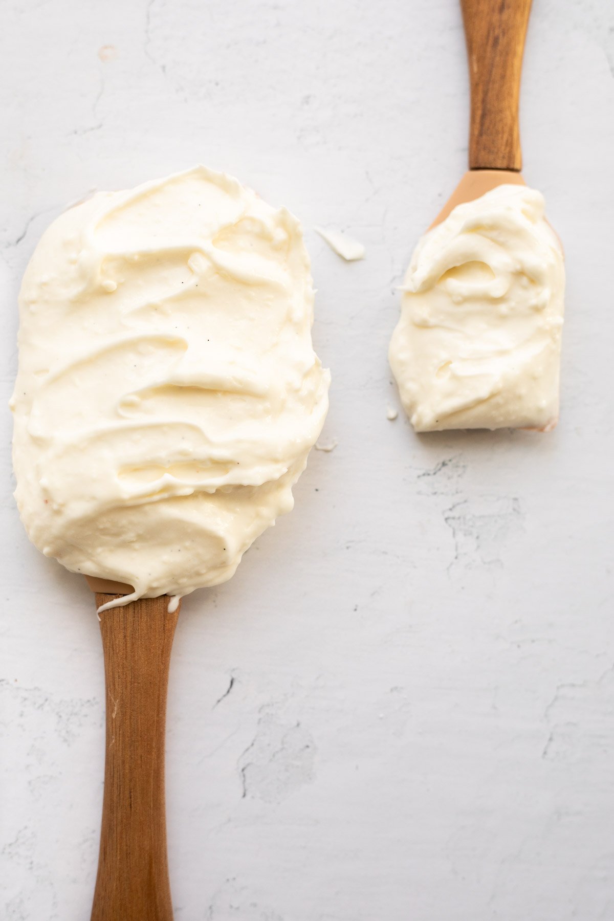 cream cheese frosting without butter on 2 spatulas.