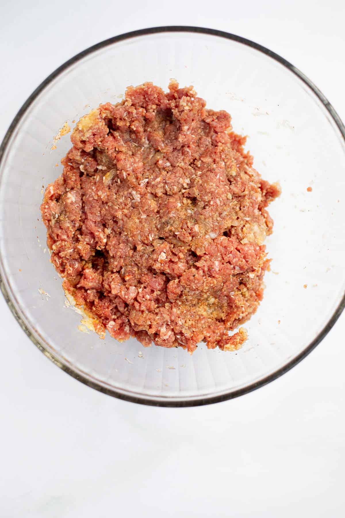 ground beef meat ball mixture in a glass bowl.