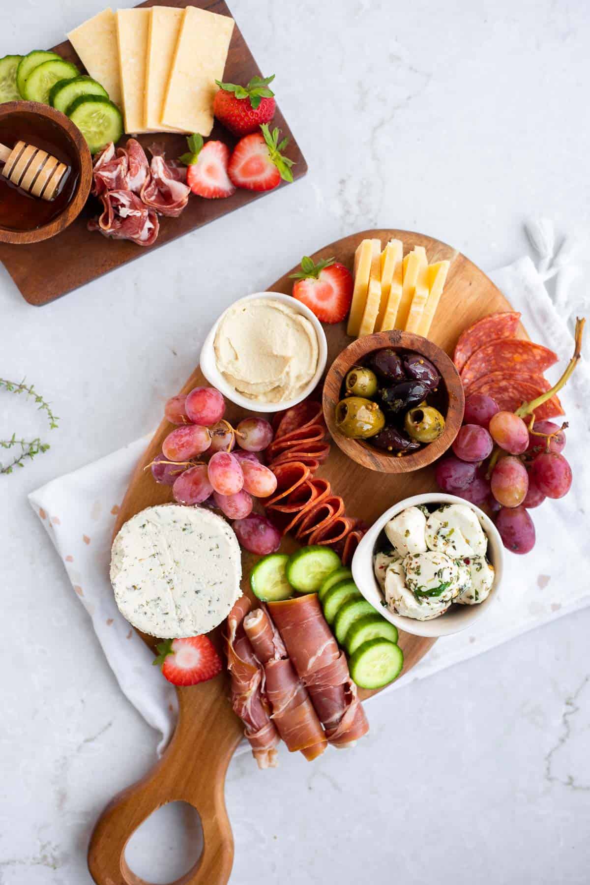 fruit and veggies added to a small cheese board.