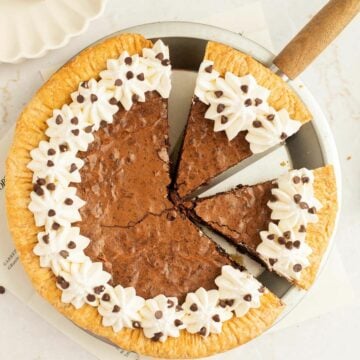 brownie pie with whipped cream and mini chocolate chips around the edges.