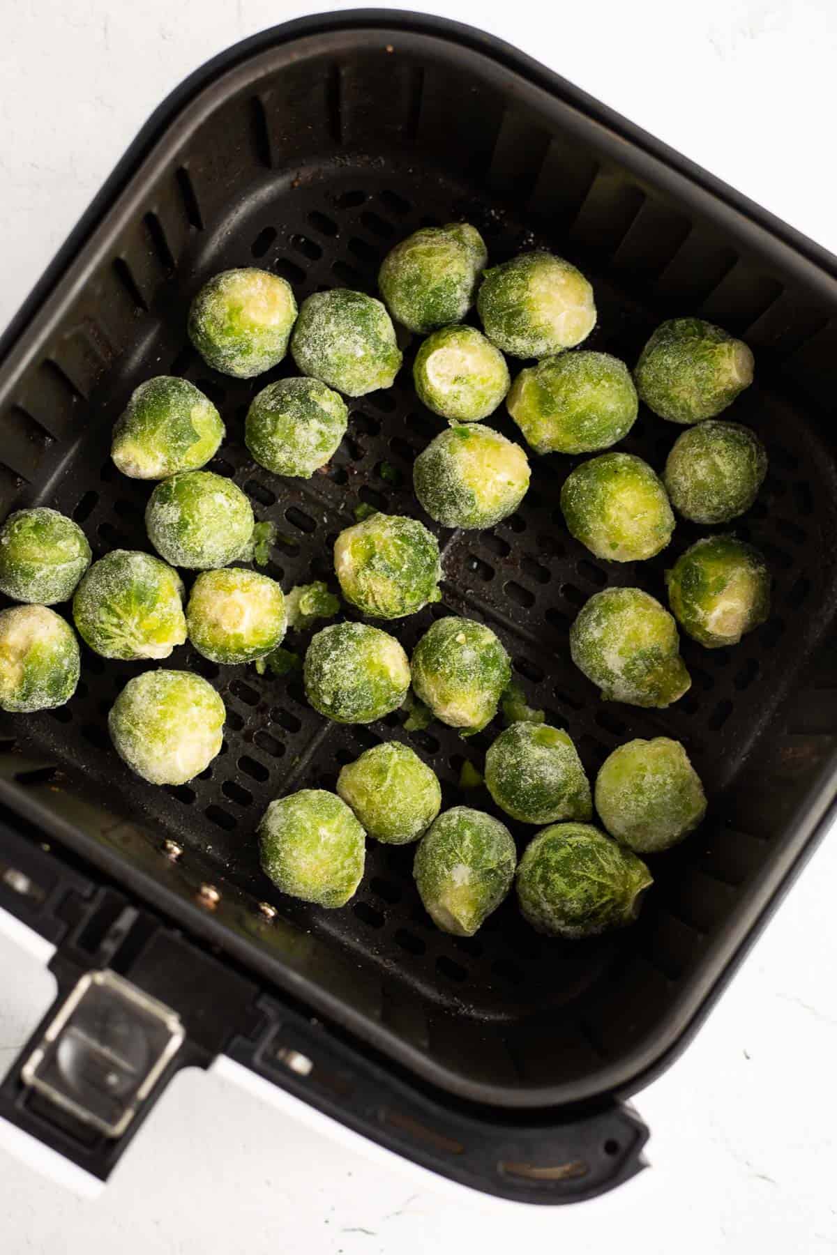 frozen brussels sprouts in air fryer basket.
