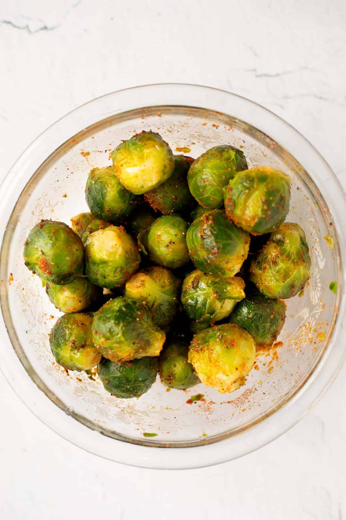 sprouts seasoned with spices in glass bowl.