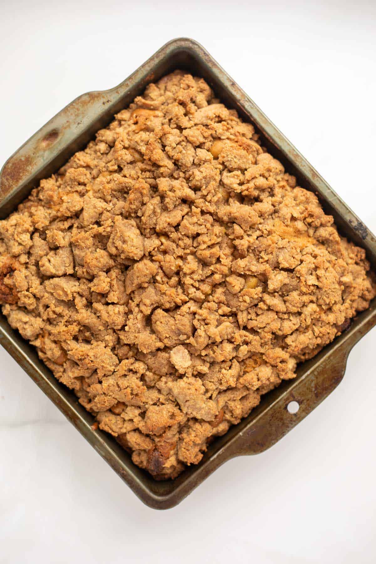 a gluten free coffee cake in a square metal baking dish.