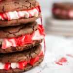 three peppermint brownie cookies stacked on each other and tied with a red ribbon.