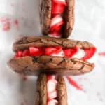 peppermint brownie cookies in a criss-cross pattern on white parchment paper.