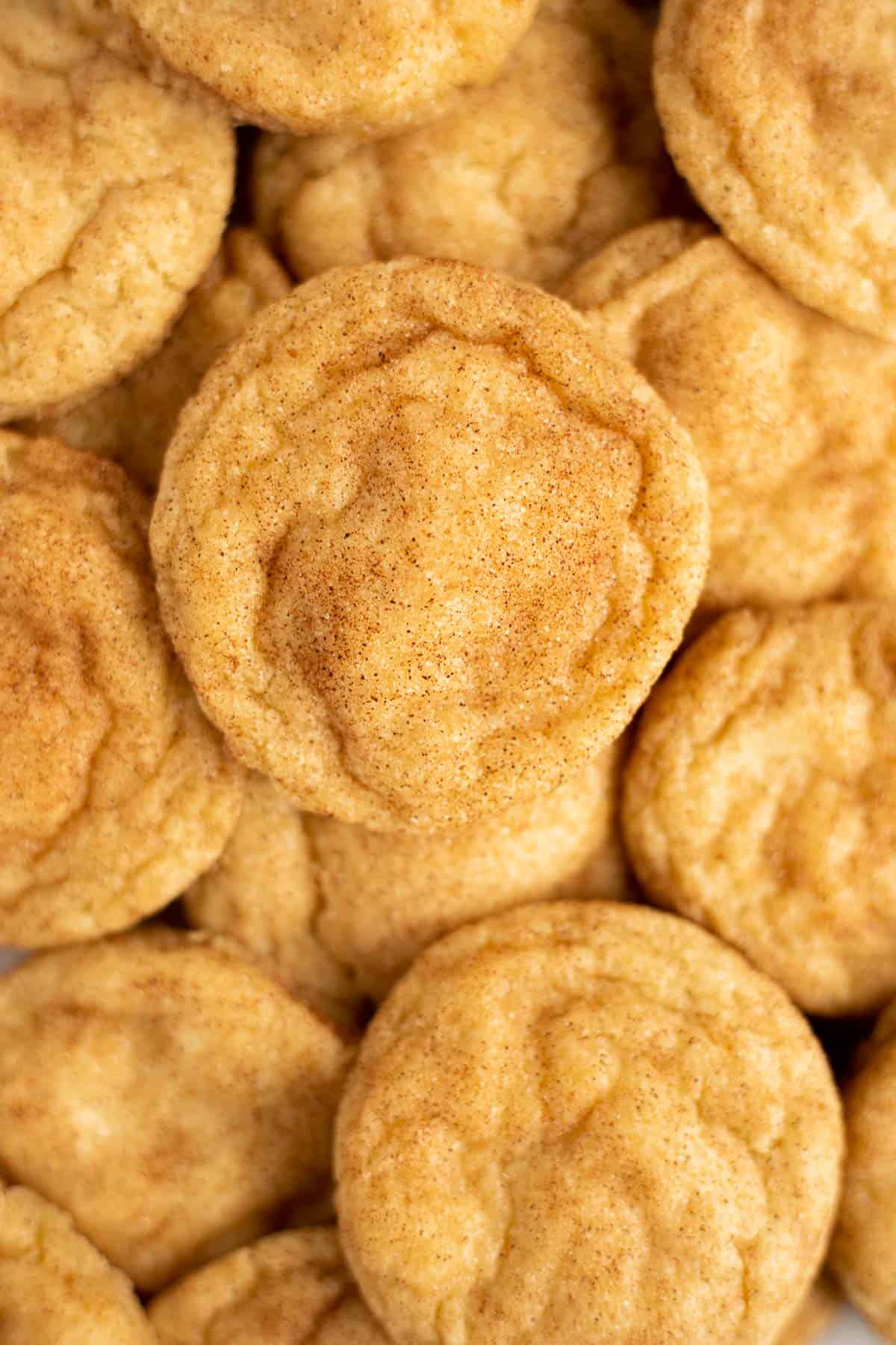 Snickerdoodles without Cream of Tartar piled on top of each other filling the entire frame.