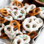 a pile of Christmas themed white chocolate pretzels.