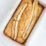 4 ingredient banana bread baked in a pink loaf pan.