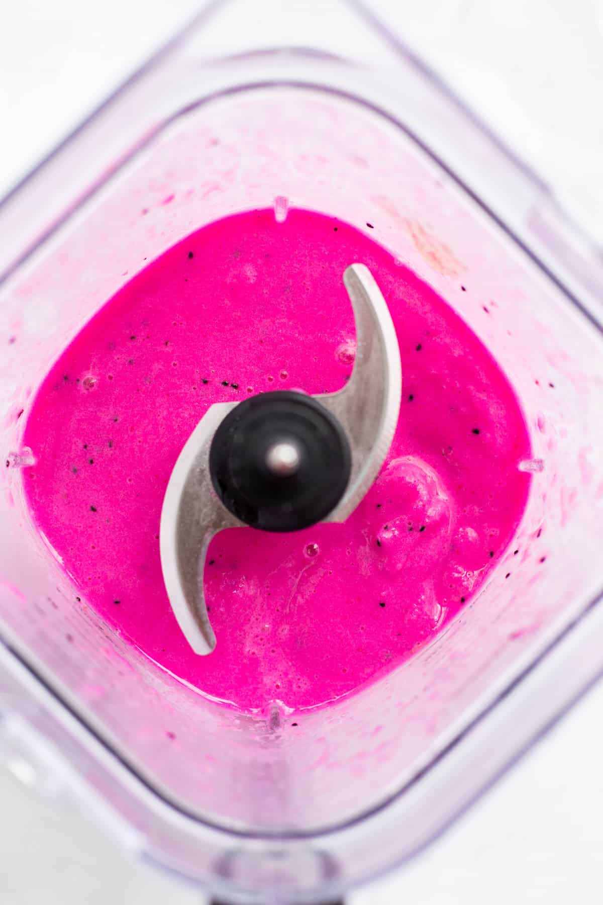 creamy pitaya smoothie in a blender cup with the blade.