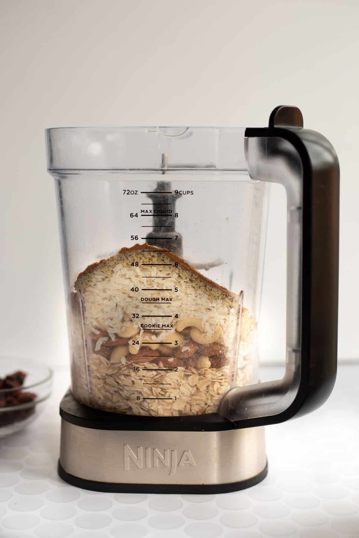 oats, nuts, hemp seeds, and cinnamon in a large blender cup.