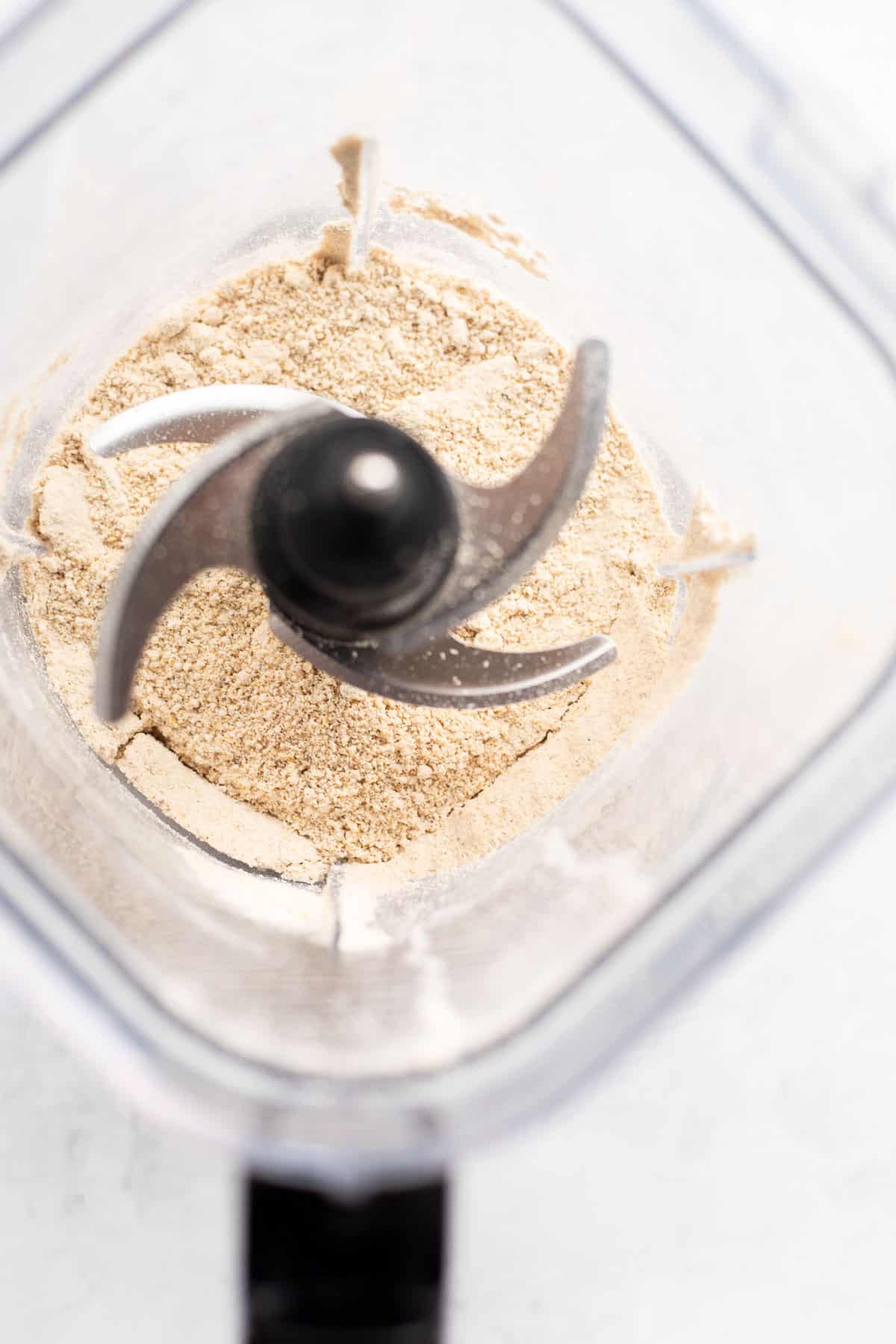 oats and hemp seeds blended into powder in a blender.