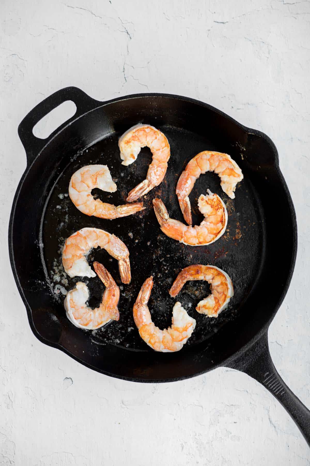 shrimp cooked in a cast iron pan.