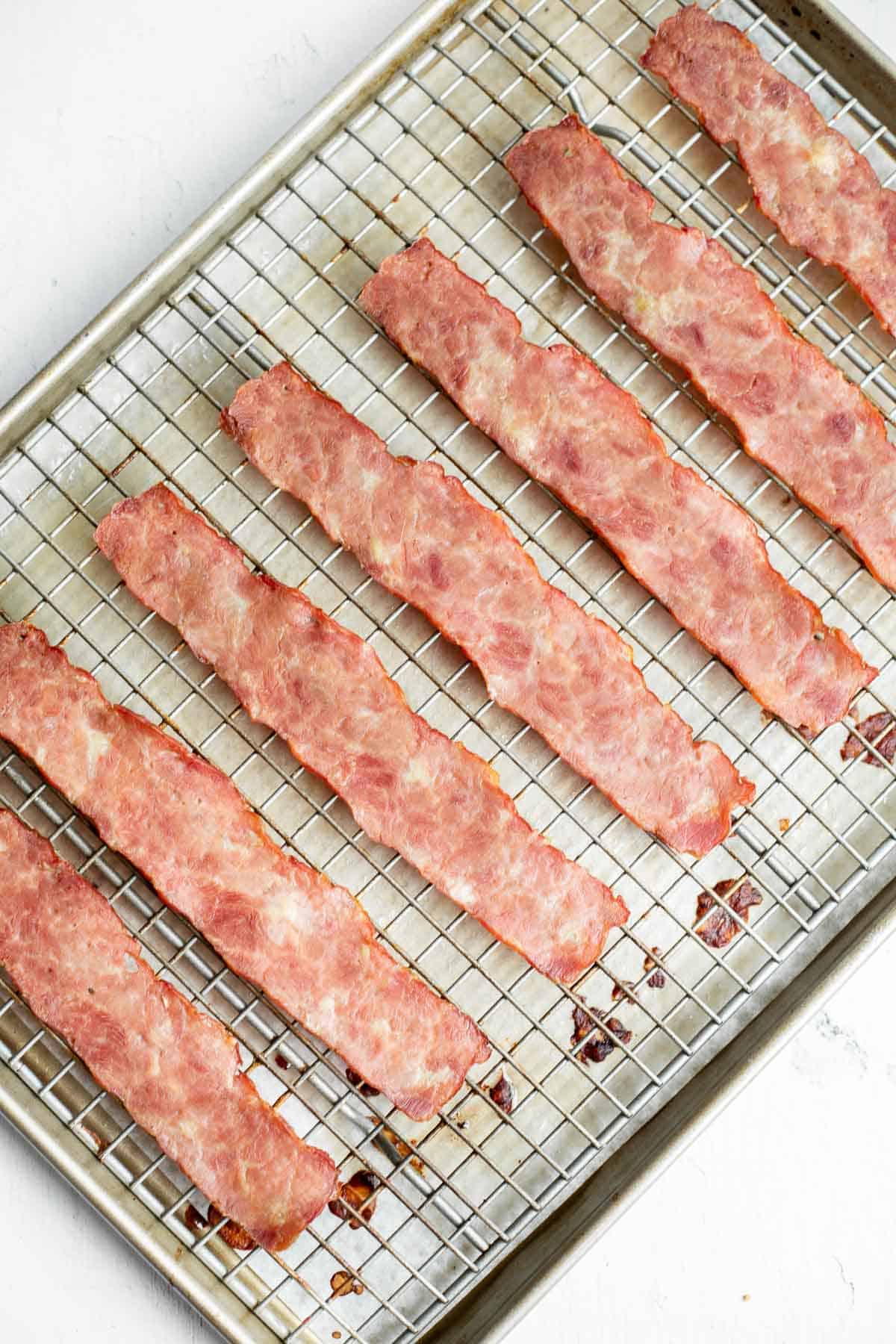 oven baked turkey bacon on baking sheet with wire rack.