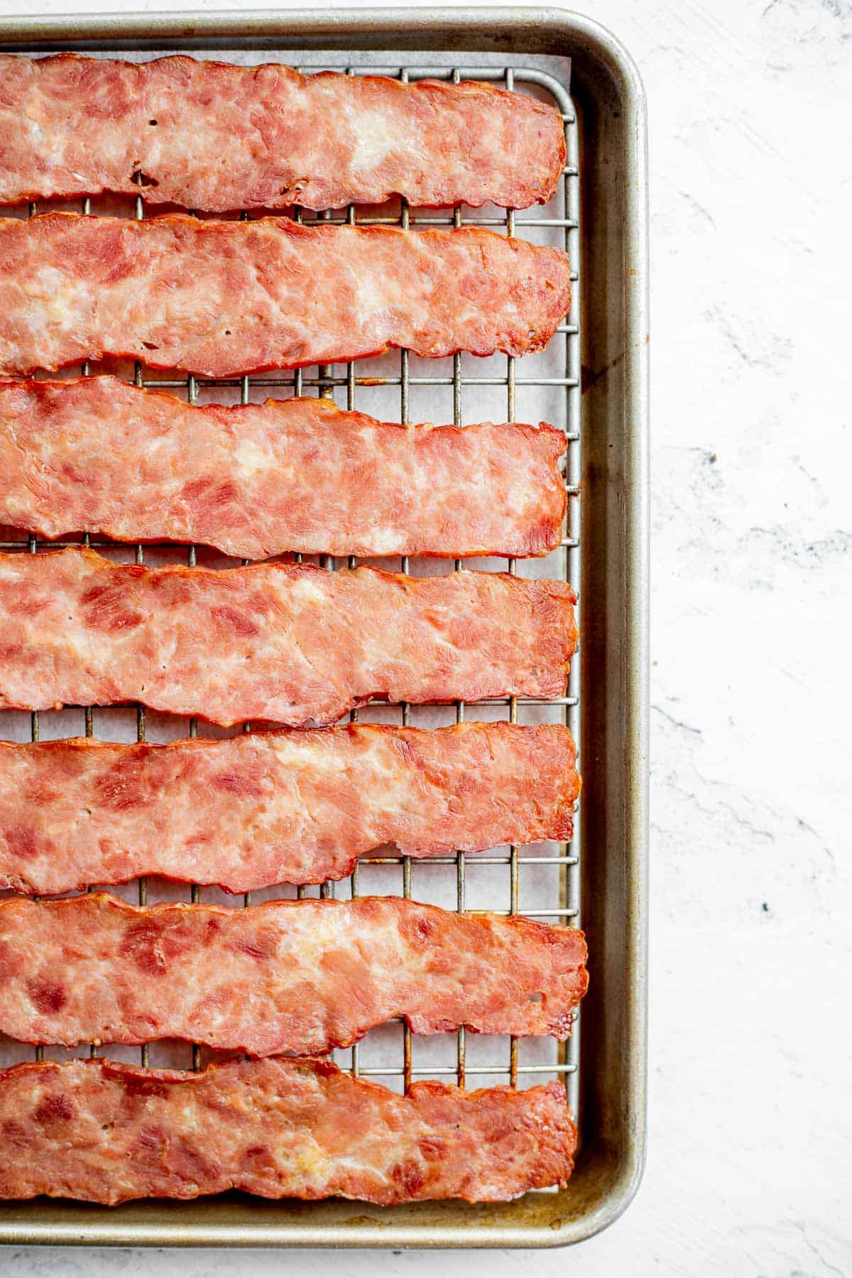 oven baked turkey bacon on wire rack on baking sheet.