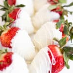white chocolate covered strawberries in a line.