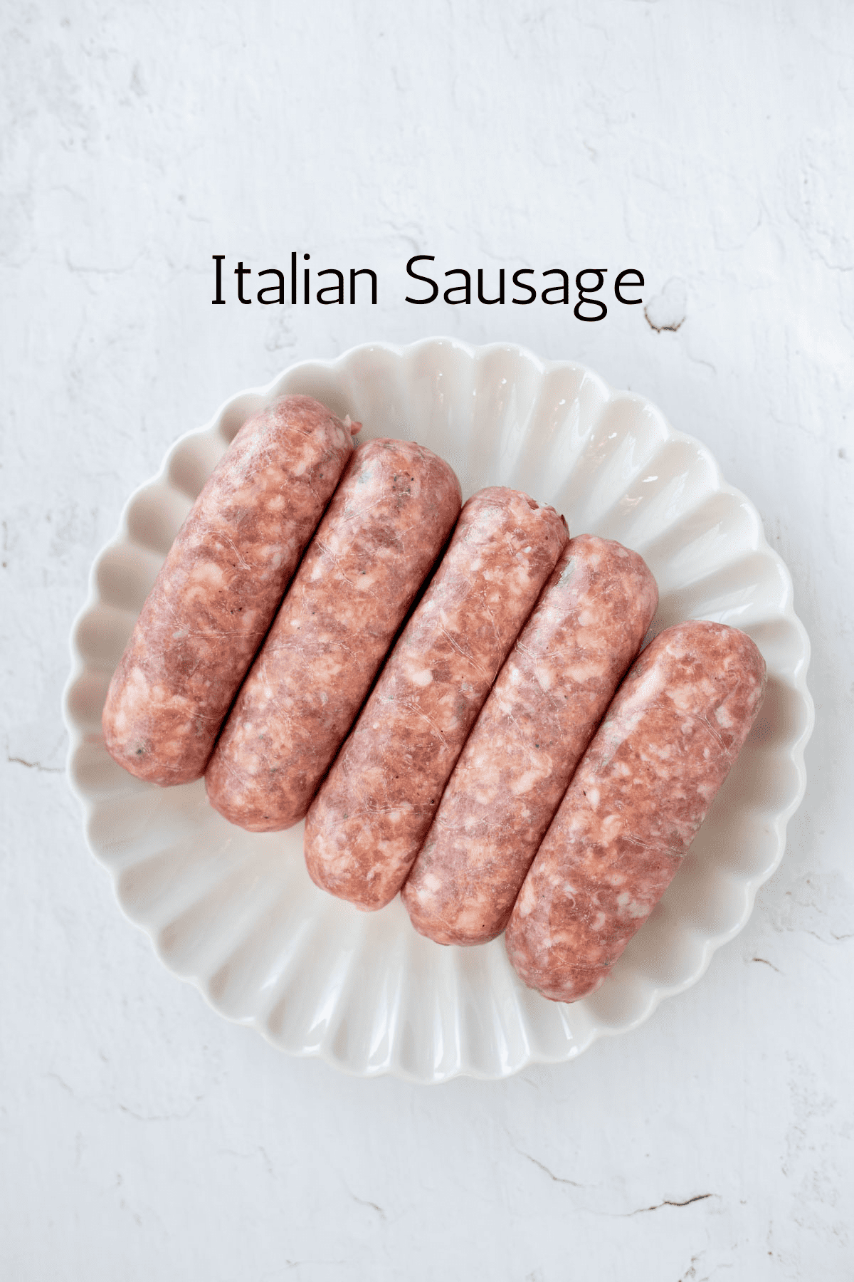 5 Italian sausage links on a white plate with black text reading Italian sausage.