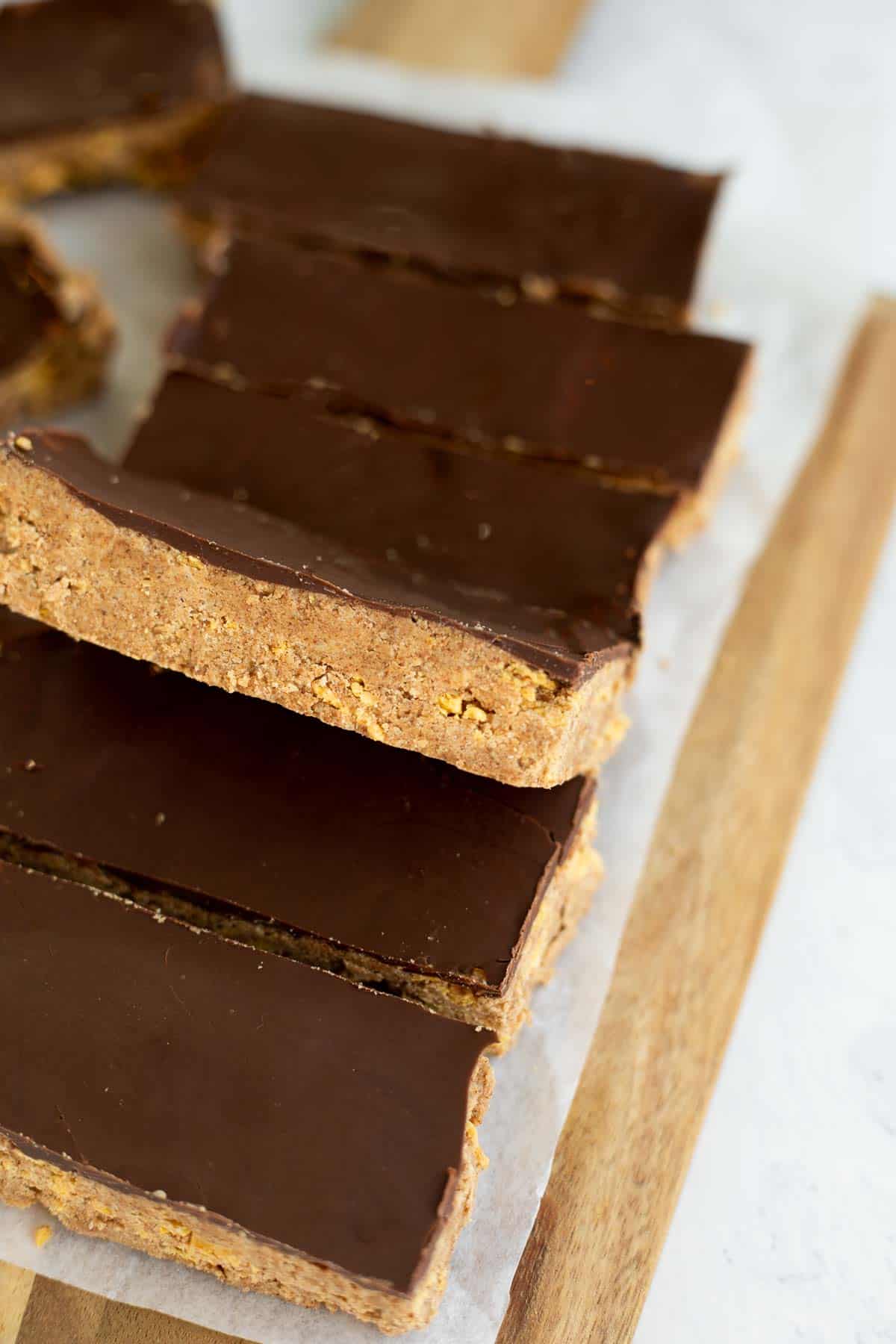 gluten free protein bars with a chocolate top on parchment paper.