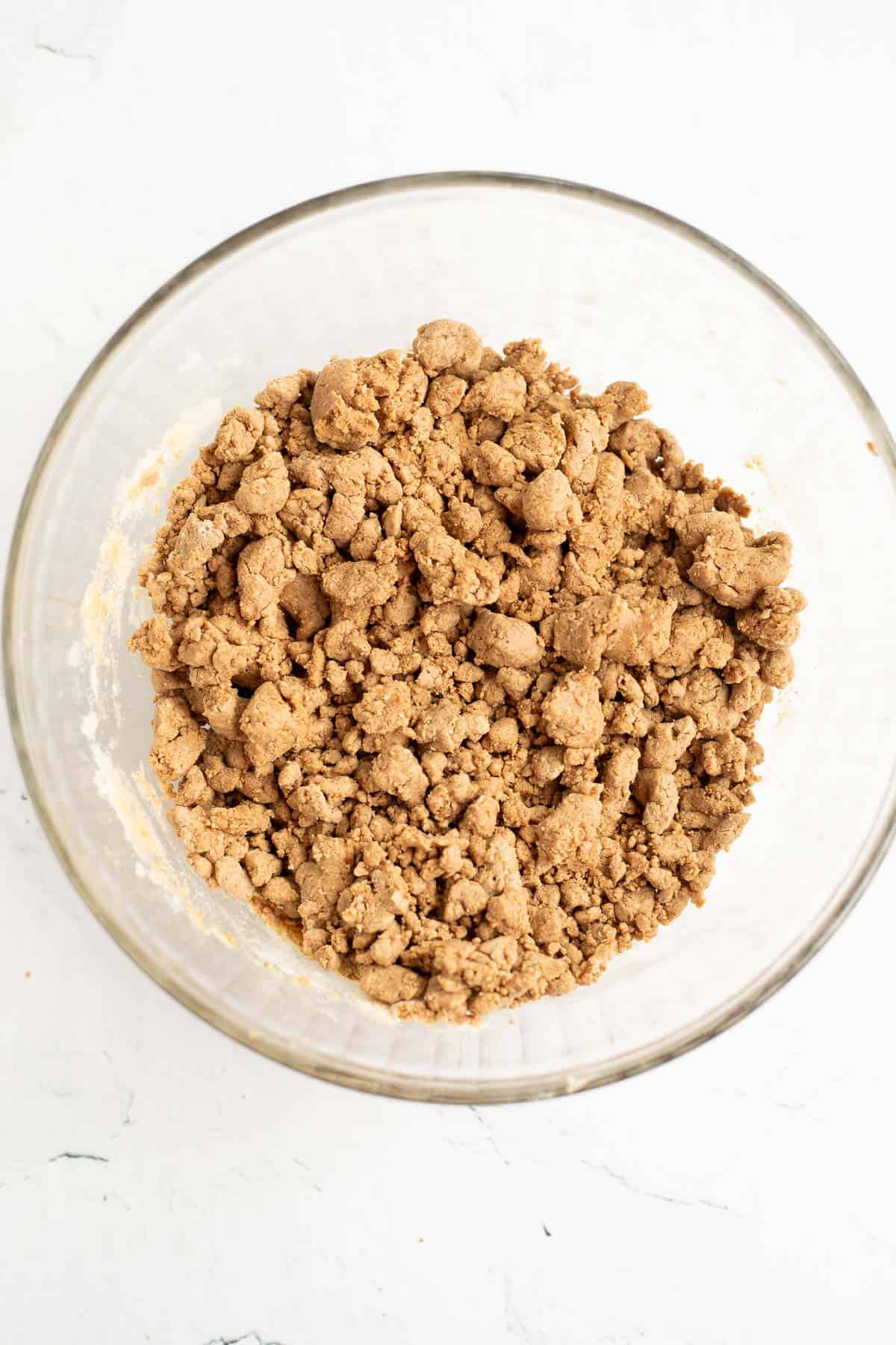 crumbly protein bar mixture in a glass bowl.