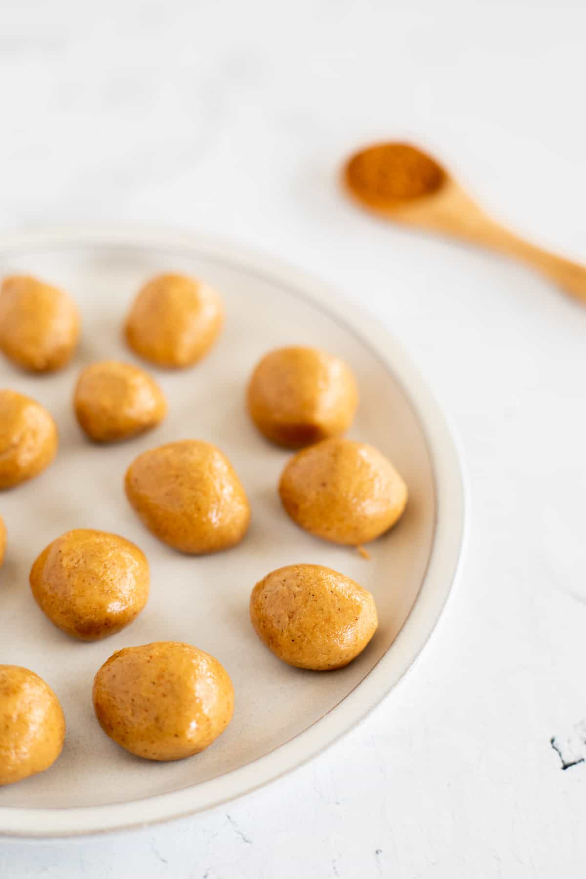 balls of sweetened peanut butter filling on a white plate.