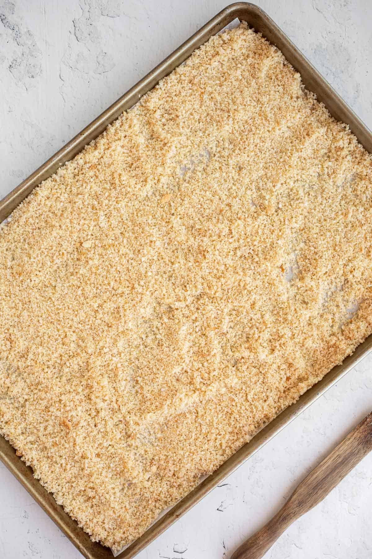 crumbs of bread and oil on a parchment lined baking sheet.