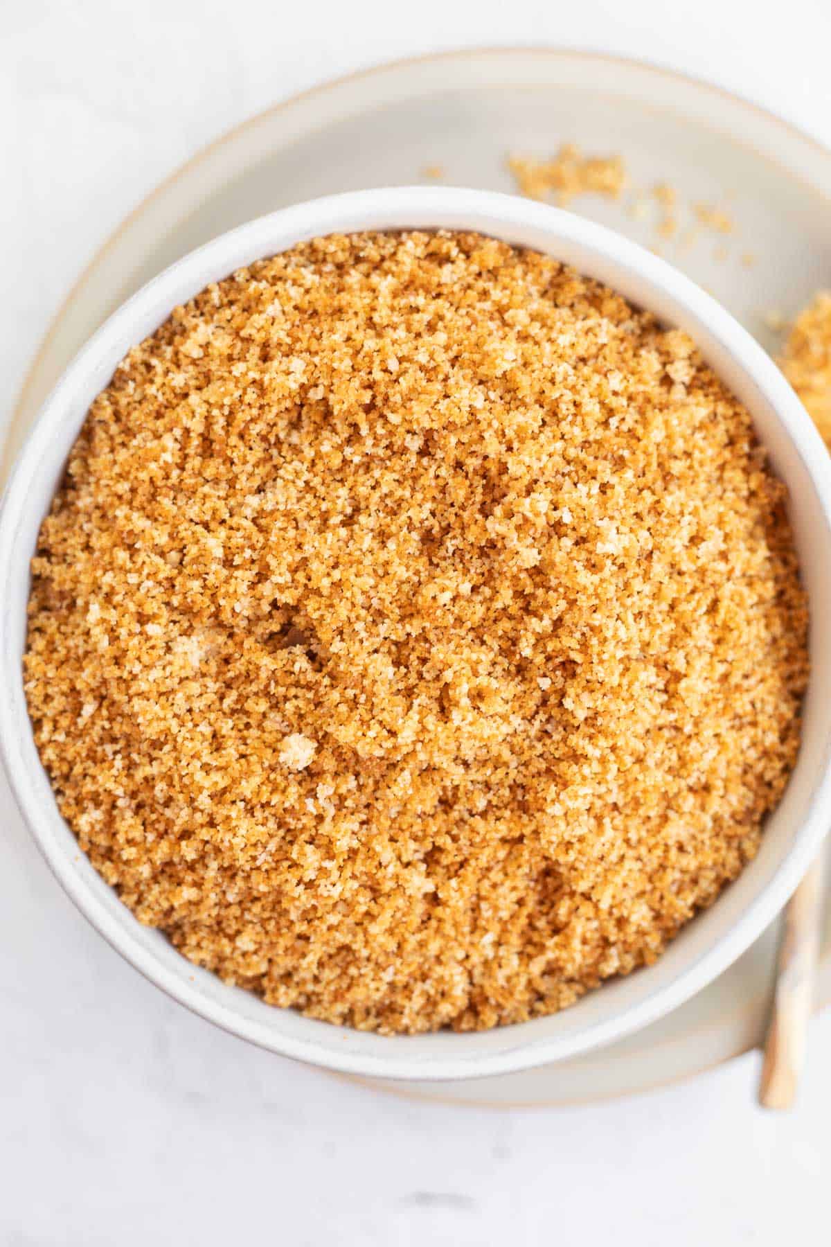 a white bowl filled with homemade gluten free bread crumbs.