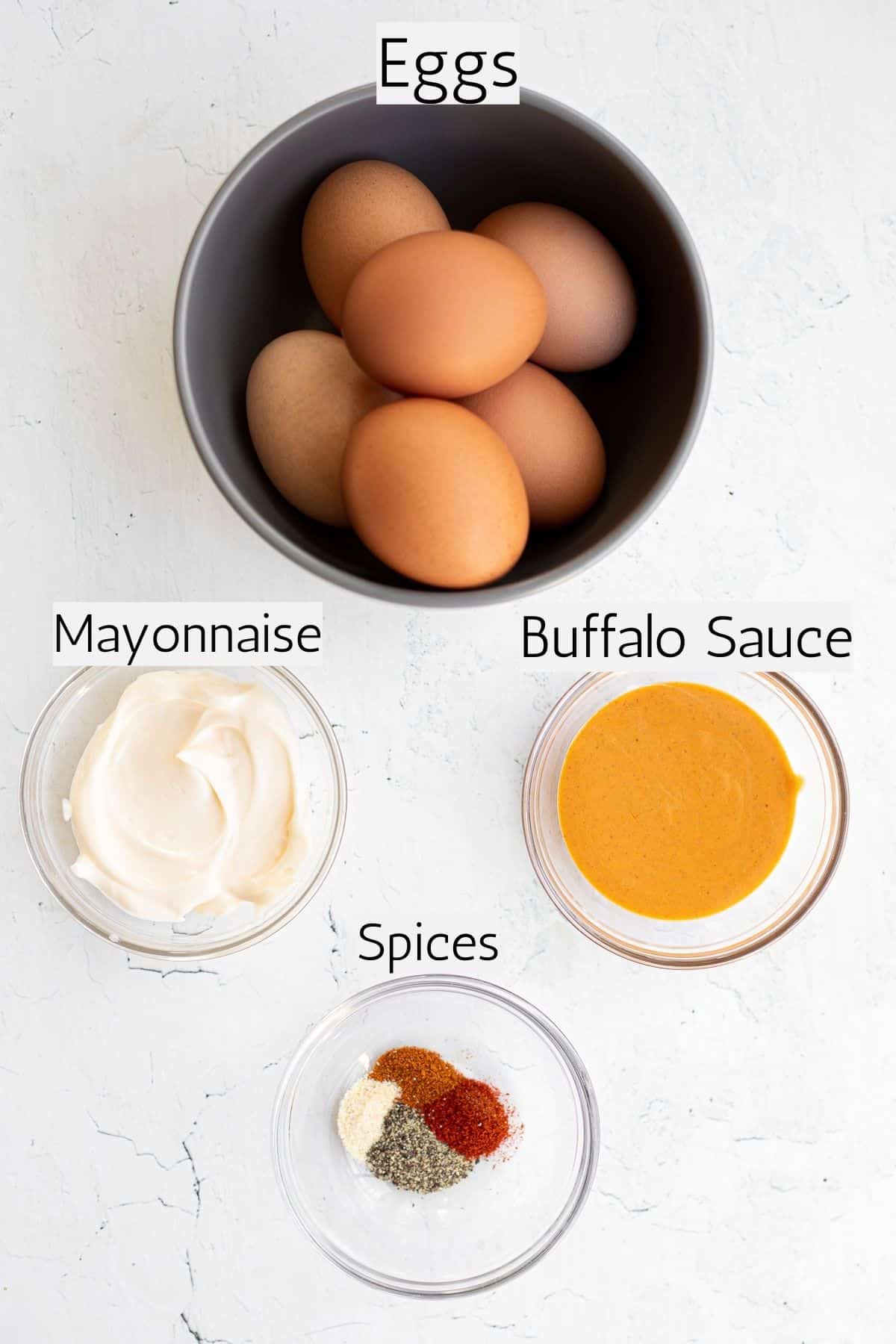 ingredients to make spicy deviled eggs labeled with black text.