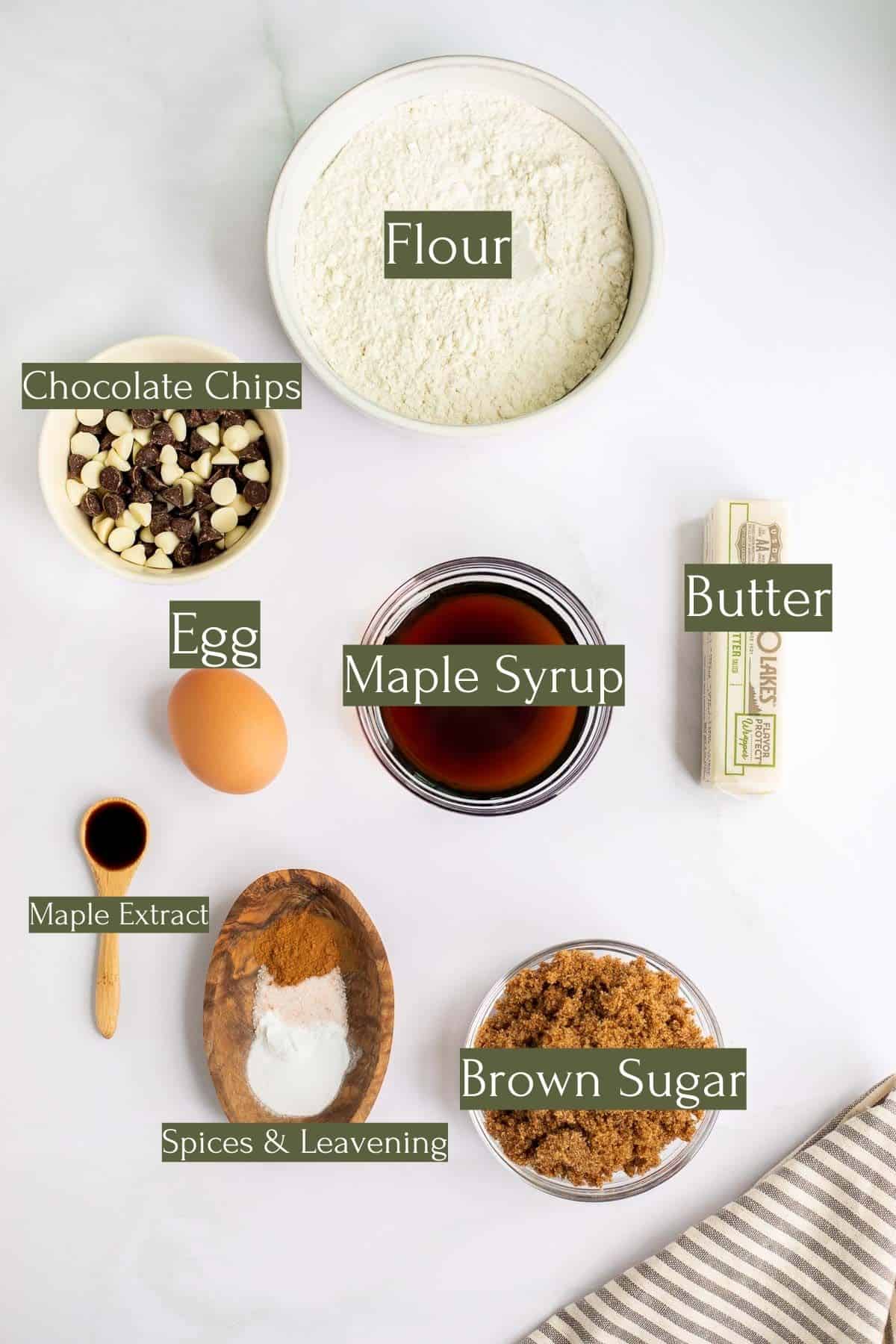 ingredients to make maple syrup chocolate chip cookies labeled with green text boxes and white words.