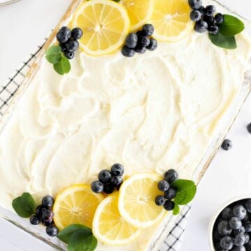 lemon blueberry sheet cake decorated with blueberries and lemon slices.