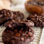 2 eggless chocolate cookies stacked with a bite taken out of the top one.