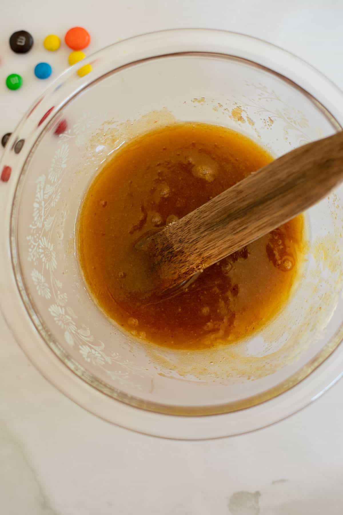melted butter, brown sugar, and egg yolk mixed in a glass bowl.