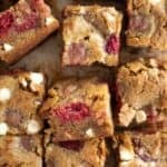 squares of brown butter blondies with raspberries and white chocolate.