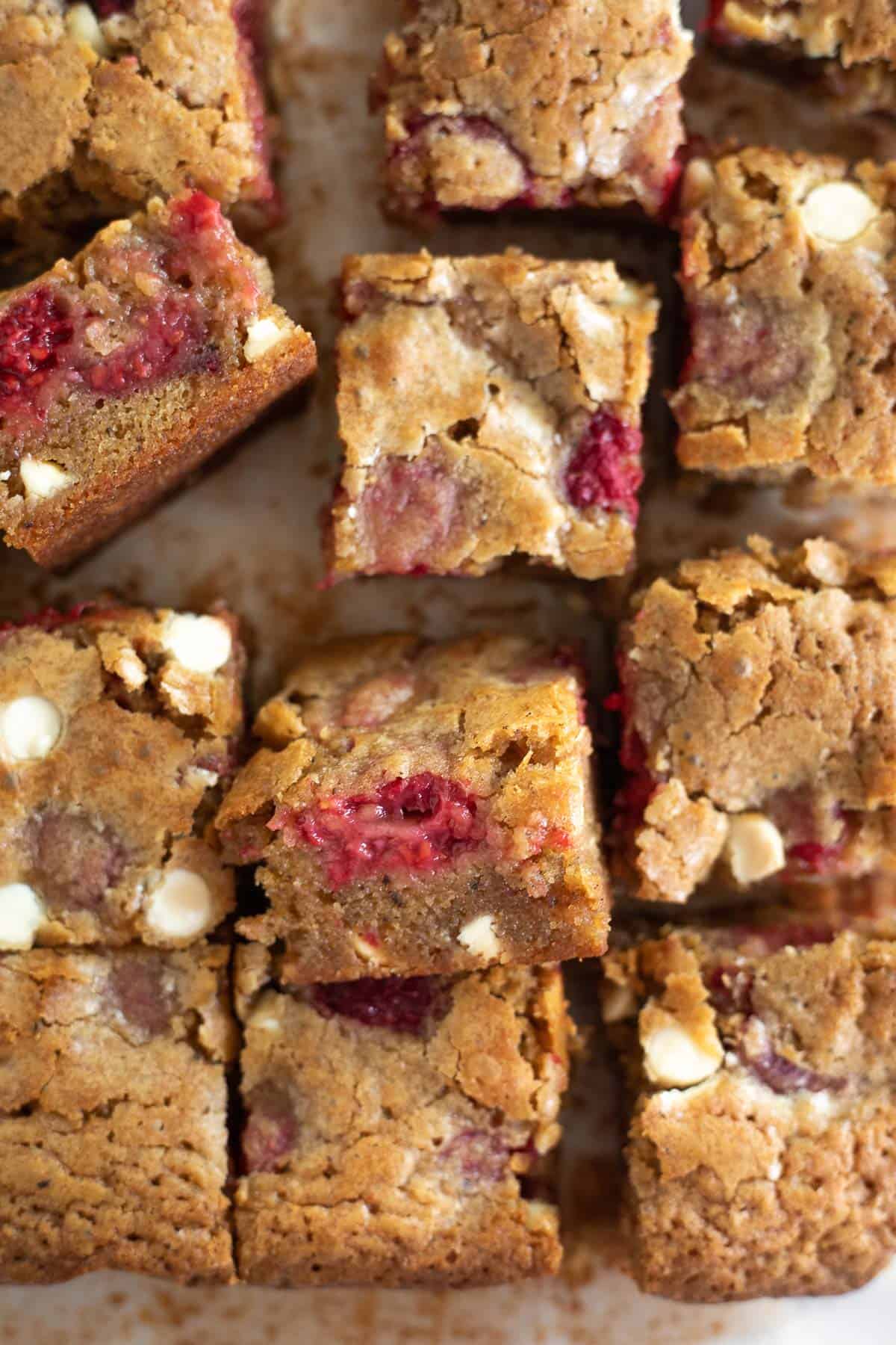 squares of brown butter blondies with raspberries and white chocolate.