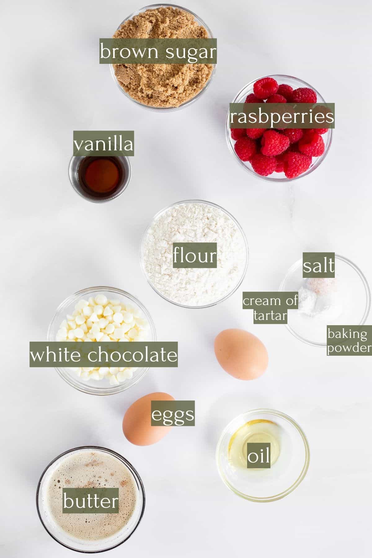 Ingredients to make blondies with white chocolate and raspberries labeled with green text boxes.