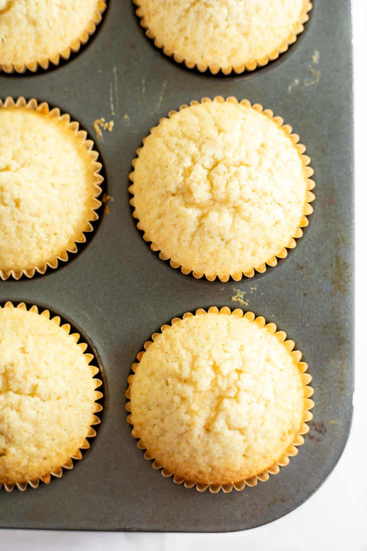 the best vanilla cupcakes baked in a muffin pan.