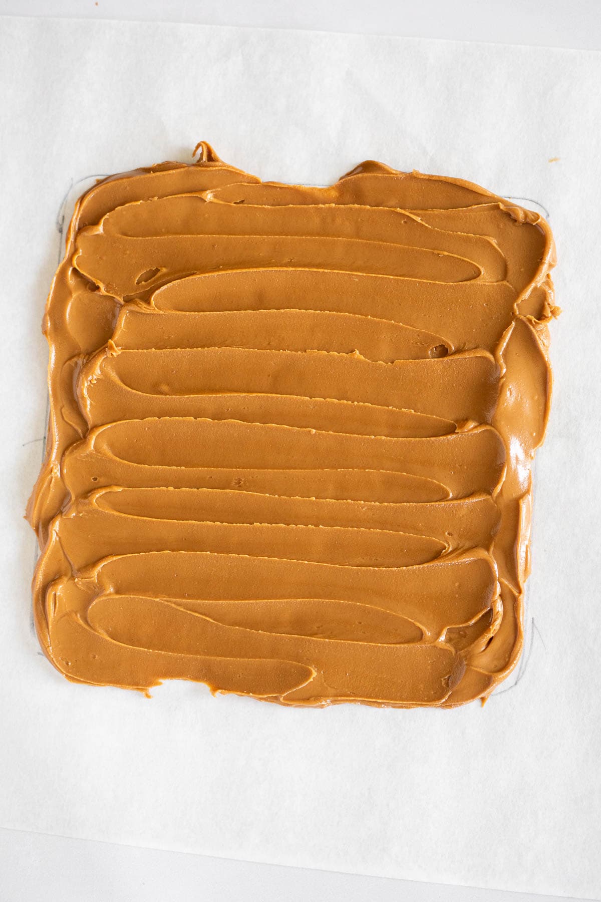 a square of cookie butter on parchment paper.