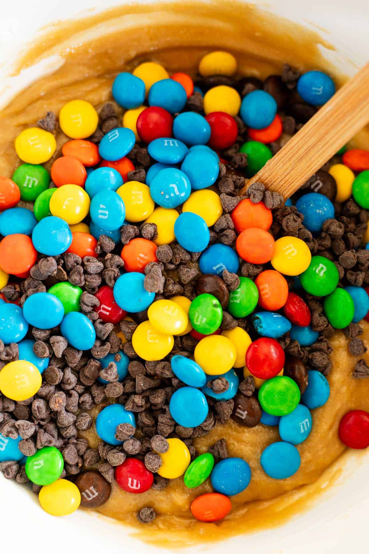 M&Ms and mini chocolate chips in cookie dough.