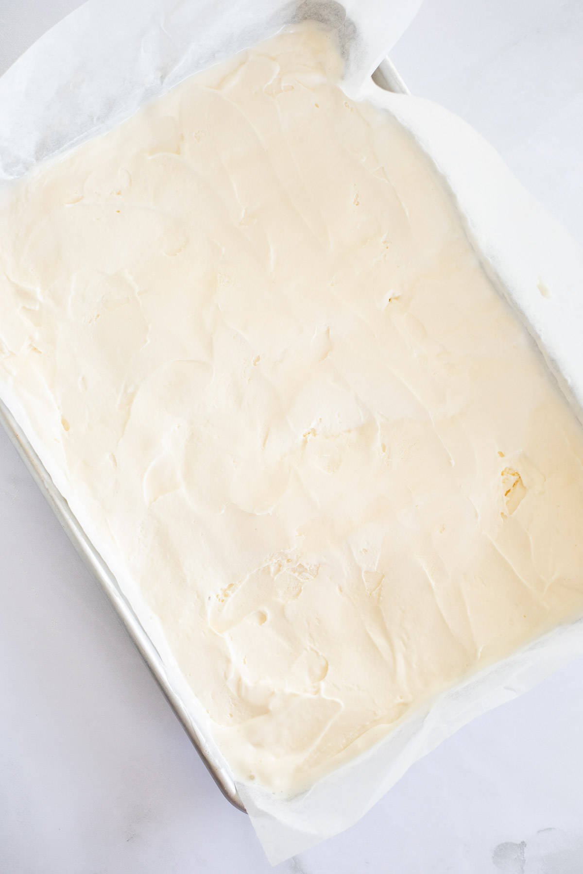 vanilla ice cream spread into a baking sheet.