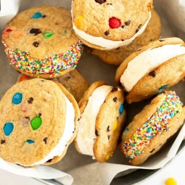 overhead photo of M&M cookie ice cream sandwiches in a tin.