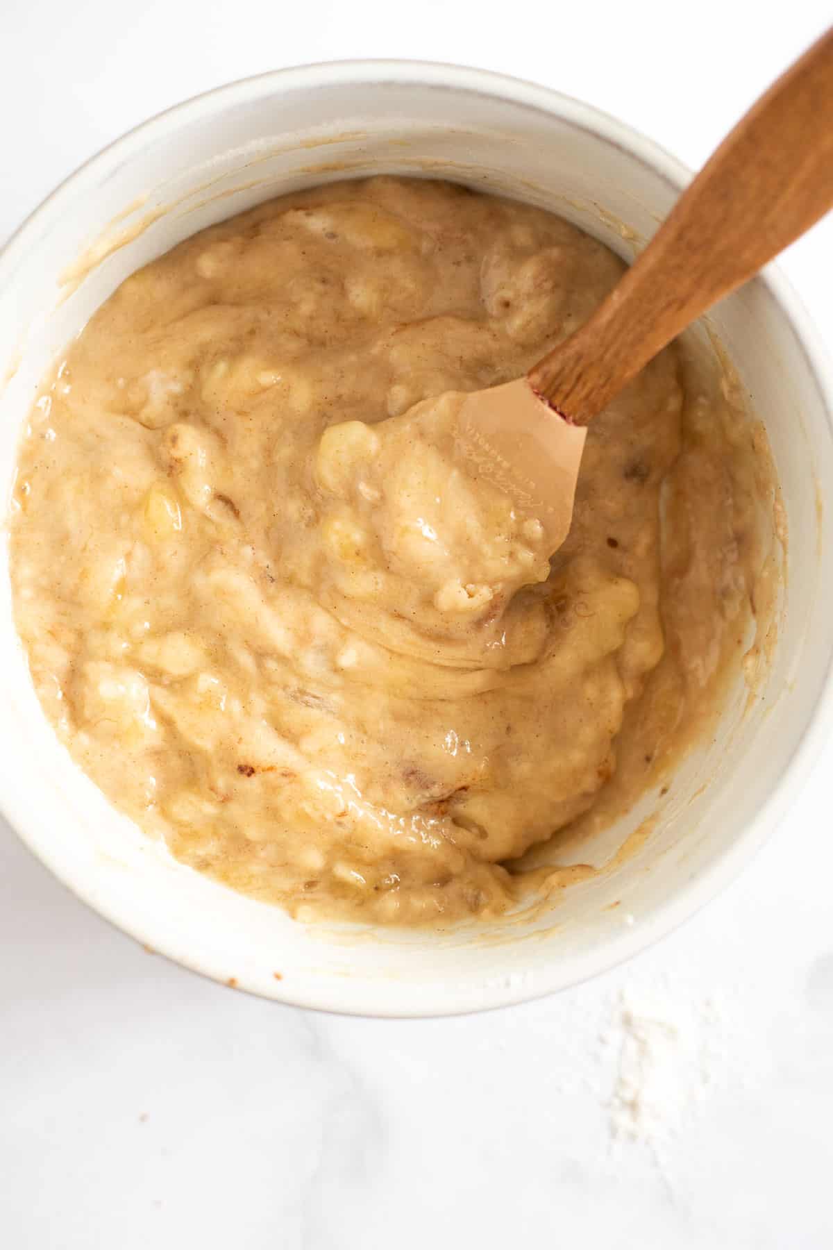 small batch banana bread batter in a white bowl.