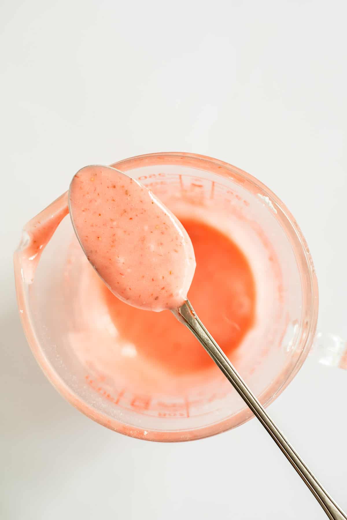 strawberry glaze dripping off a spoon.