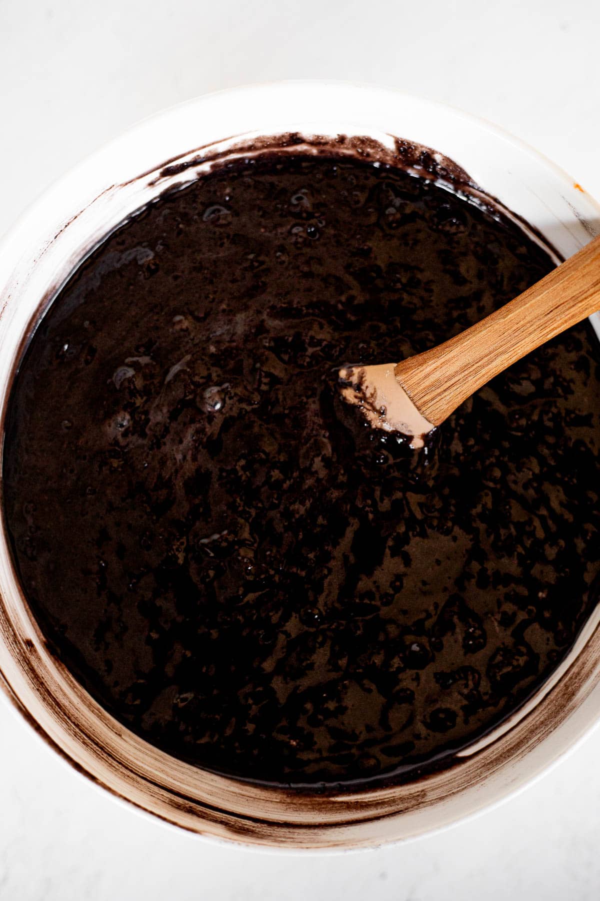 black cocoa cake batter in a white bowl.