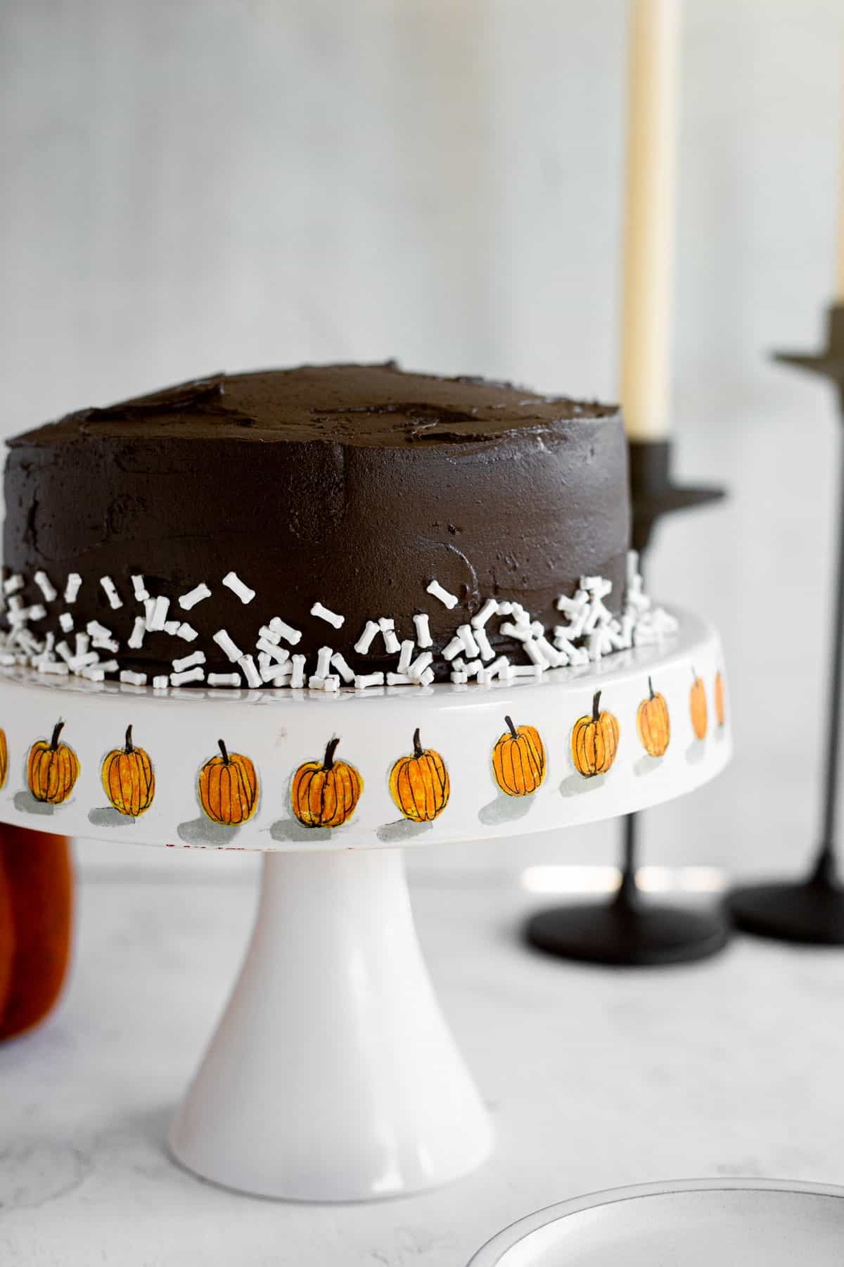 layered Halloween black velvet cake on a pumpkin cake stand.