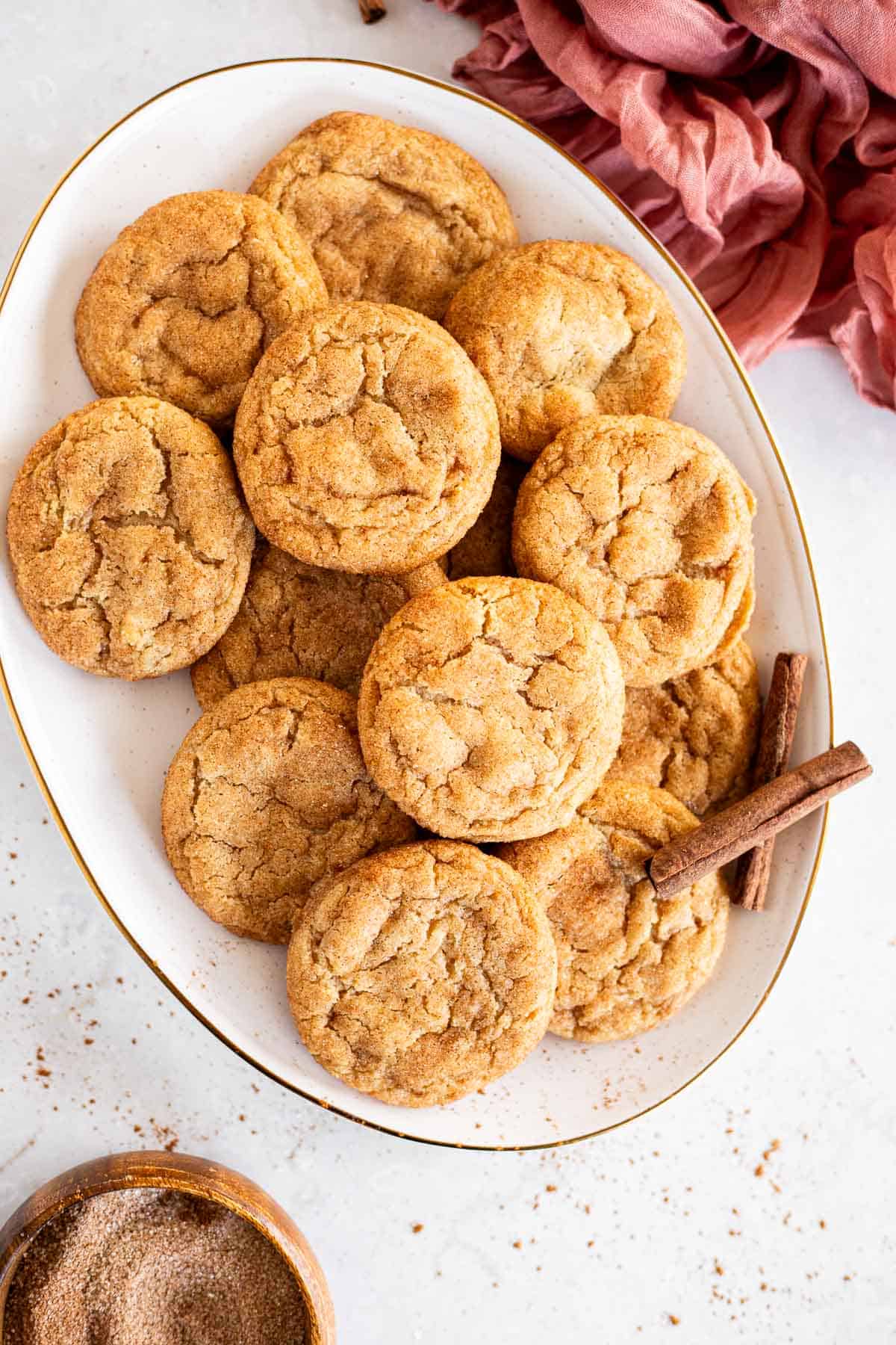 brown butter snickerdoodles piled on a white platter.