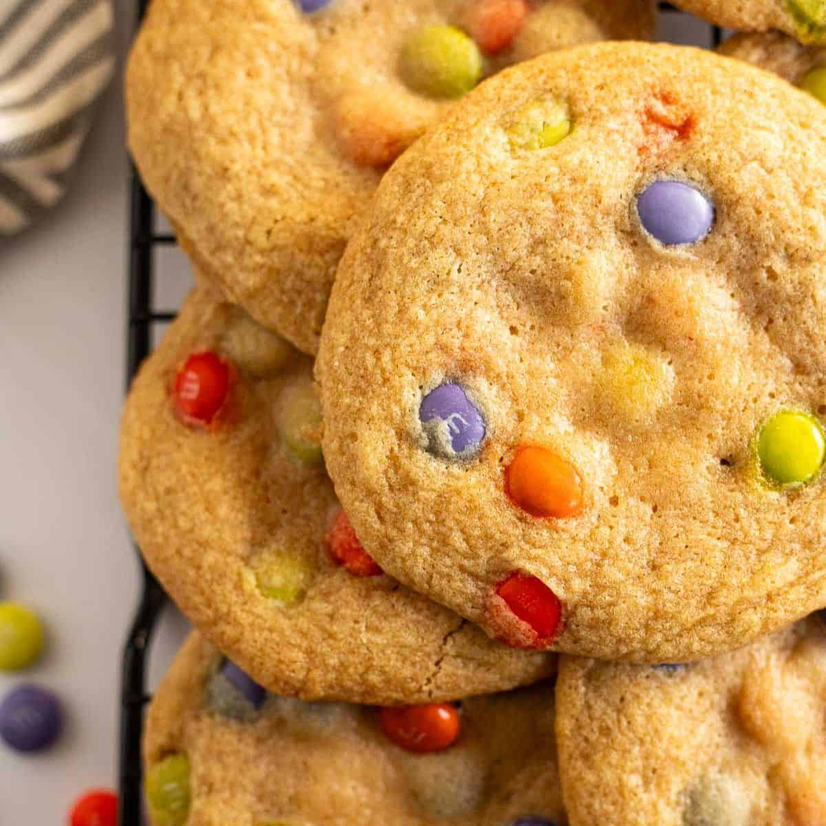 overhead photos of Halloween M&M cookies piled on a wire rack.