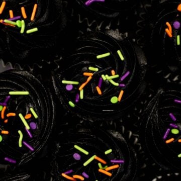 overhead photo of black velvet cupcakes with halloween sprinkles.